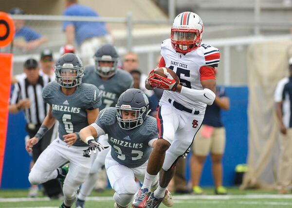 Creekview sophomore linebacker Will Michaud tackles Sandy Creek sophomore wide receiver Major Weems (15) in the first half during the Corky Kell Classic at McEachern's Walter H. Cantrell Stadium on Aug. 21, 2015. (Daniel Varnado/Special to the AJC)