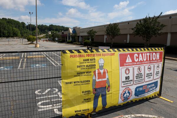 A sign for personal protection equipment is shown outside of gates to the North DeKalb Mall, Monday, June 24, 2024, in Decatur, Ga. The North DeKalb mall is scheduled to be demolished starting Wednesday morning, June 26th. (Jason Getz / AJC)
