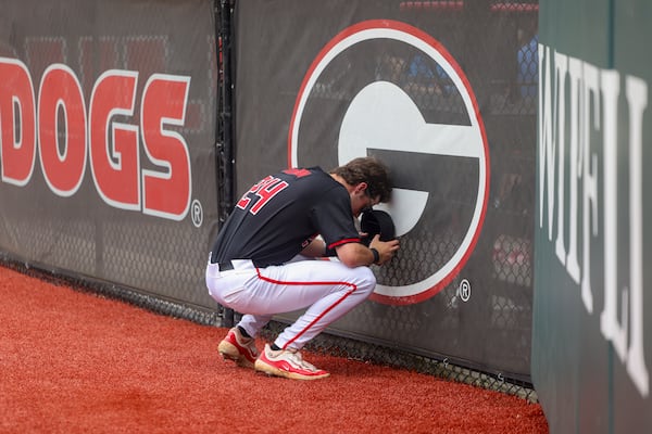 Georgia third baseman Charlie Condon (24) prays in front of the “G” before their game against Vanderbilt at Foley Field, Friday, May 3, 2024, in Athens, Ga.  (Jason Getz / AJC)
