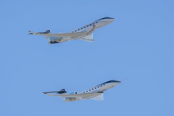 The G700 (top) and G800 perform a fly-over during an event to celebrate the newly certified Gulfstream Aerospace Corp. G700 on Thursday, April 4, 2024, in Savannah, Ga. (Stephen B. Morton for the AJC)