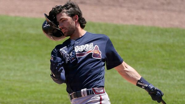 Atlanta Braves shortstop Dansby Swanson (7) loses his helmet as he swings during the fourth inning of a spring training game Tuesday, March 30, 2021, against the Boston Red Sox in Fort Myers, Fla. (John Bazemore/AP)