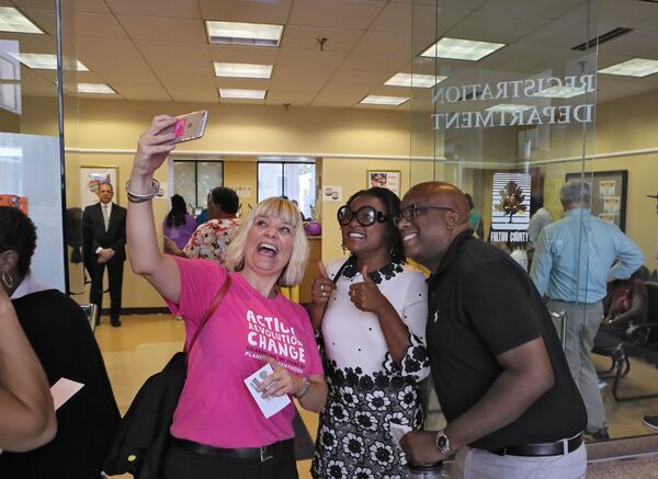 October 17, 2016 - Atlanta - Voters take a photo with state Rep. Park Cannon (center), D-Atlanta, as they wait to vote at the Fulton County Government Center. Congressman John Lewis, Fulton County Chairman John Eaves and state Rep. Park Cannon, D-Atlanta, led young Democrats on a march from the Nelson Street Bridge to the Fulton County Government Center where the first day of early voting had begun. BOB ANDRES /BANDRES@AJC.COM