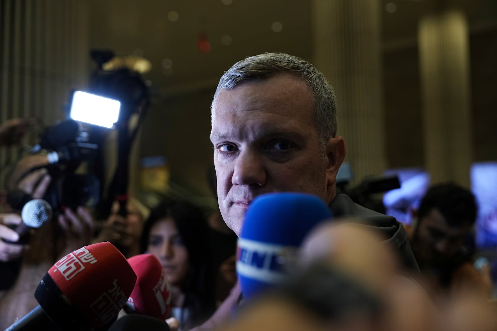 Ben Mansford, CEO of Maccabi Tel Aviv, speaks to the media as he arrives at Israel's Ben-Gurion International Airport on a flight from Amsterdam, where Israeli soccer fans were attacked following a match between the Israeli club and Ajax Amsterdam, in Lod, Israel, Friday, Nov. 8, 2024. (AP Photo/Tsafrir Abayov)