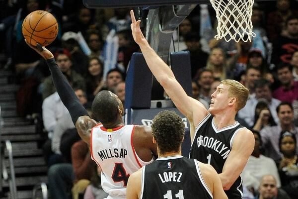 Atlanta Hawks forward Paul Millsap (4) shoots a Brooklyn Nets center Mason Plumlee (1) defends during the second half of an NBA basketball game, Wednesday Jan. 28, 2015, in Atlanta. Atlanta won 113-102.(AP Photo/John Amis) Here's Paul Millsap, going to the hoop. (John Amis/AP photo)