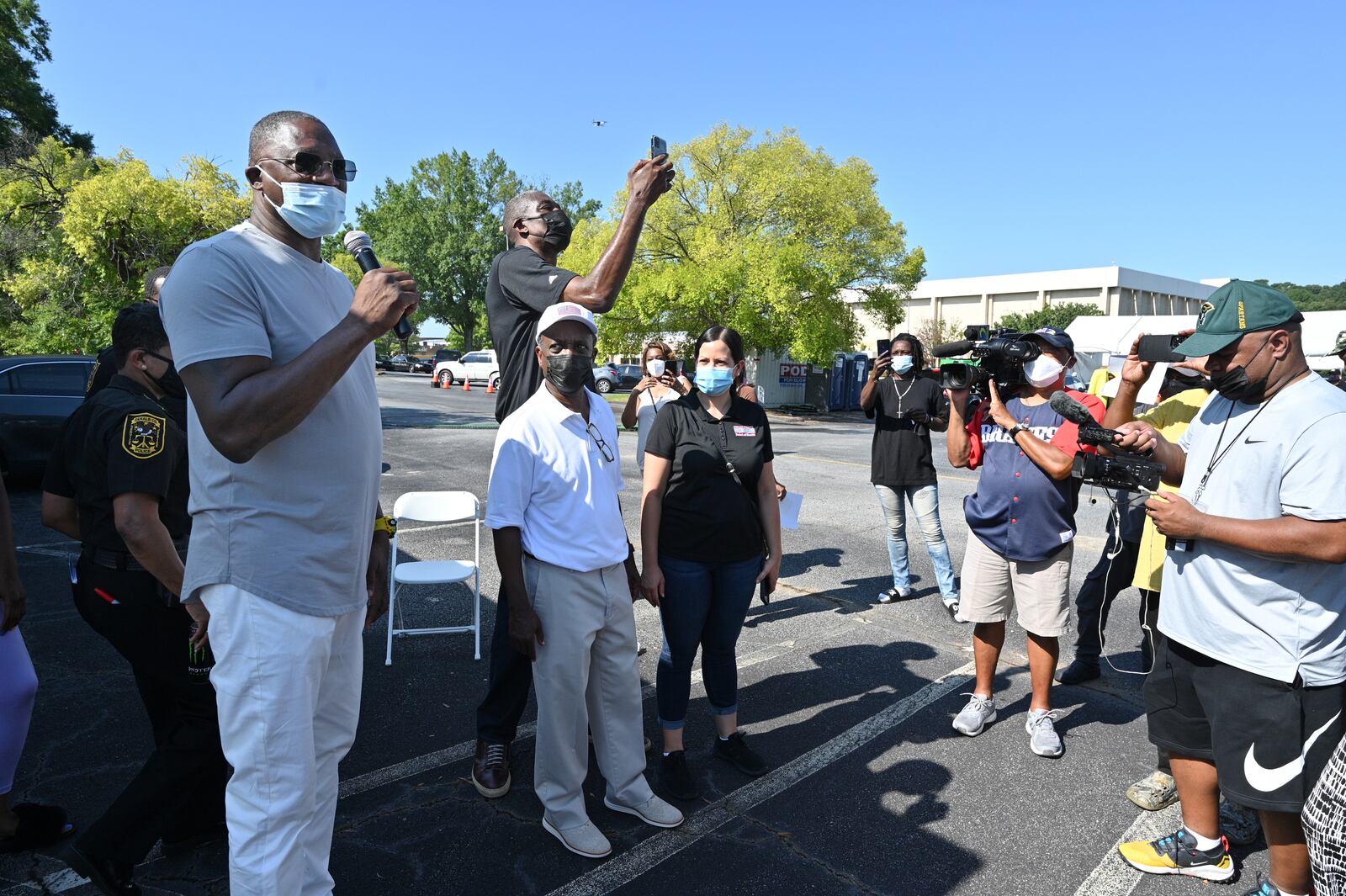 NBA legend Dominique Wilkins (left) encourages residents to get vaccinated during an event at The Gallery at South DeKalb on Saturday, Aug. 13, 2021. Wilkins is flanked by DeKalb County CEO Michael Thurmond, DeKalb District Health Director Dr. Sandra Valenciano and former Atlanta Hawk Dikembe Mutombo (rear). (Hyosub Shin / Hyosub.Shin@ajc.com)