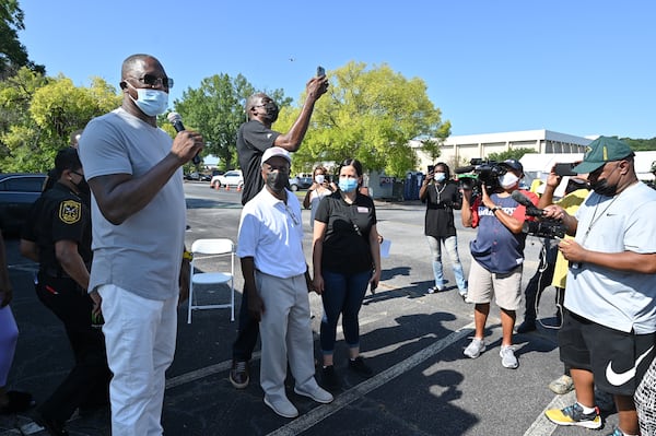 NBA legend Dominique Wilkins (left) encourages residents to get vaccinated during an event at The Gallery at South DeKalb on Saturday, Aug. 13, 2021. Wilkins is flanked by DeKalb County CEO Michael Thurmond, DeKalb District Health Director Dr. Sandra Valenciano and former Atlanta Hawk Dikembe Mutombo (rear). (Hyosub Shin / Hyosub.Shin@ajc.com)