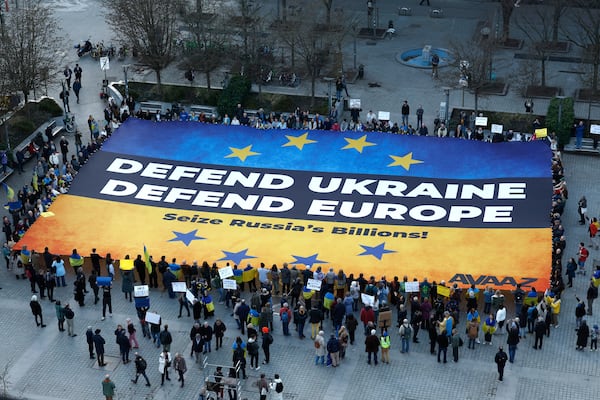 Activists unfurl a large banner in support of Ukraine outside the European Council building ahead of an EU summit in Brussels, Belgium, Wednesday, March 5, 2025. (AP Photo/Omar Havana)