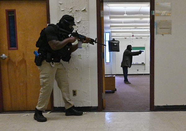 June 9, 2022 Atlanta - A law enforcement officer responses to an active shooter scenario during an active shooter training exercise held by Atlanta Police Department at former Venetian Hills Elementary School in Atlanta on Thursday, June 9, 2022. The Atlanta Police Department hosted advanced active shooter training with the department’s TFOs (tactical field officers) and the Titan unit. (Hyosub Shin / Hyosub.Shin@ajc.com)