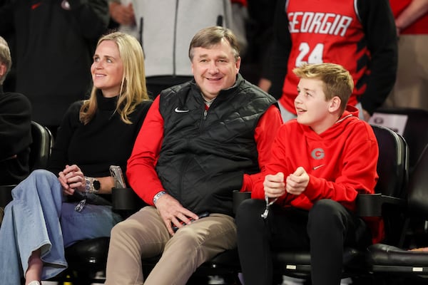 Georgia head football coach Kirby Smart takes in the game with his wife Mary Beth and son Andrew. (Jason Getz / AJC)
