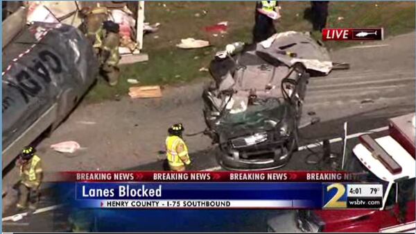 A car was destroyed after a tanker rolled on top of it. (Credit: Channel 2 Action News)