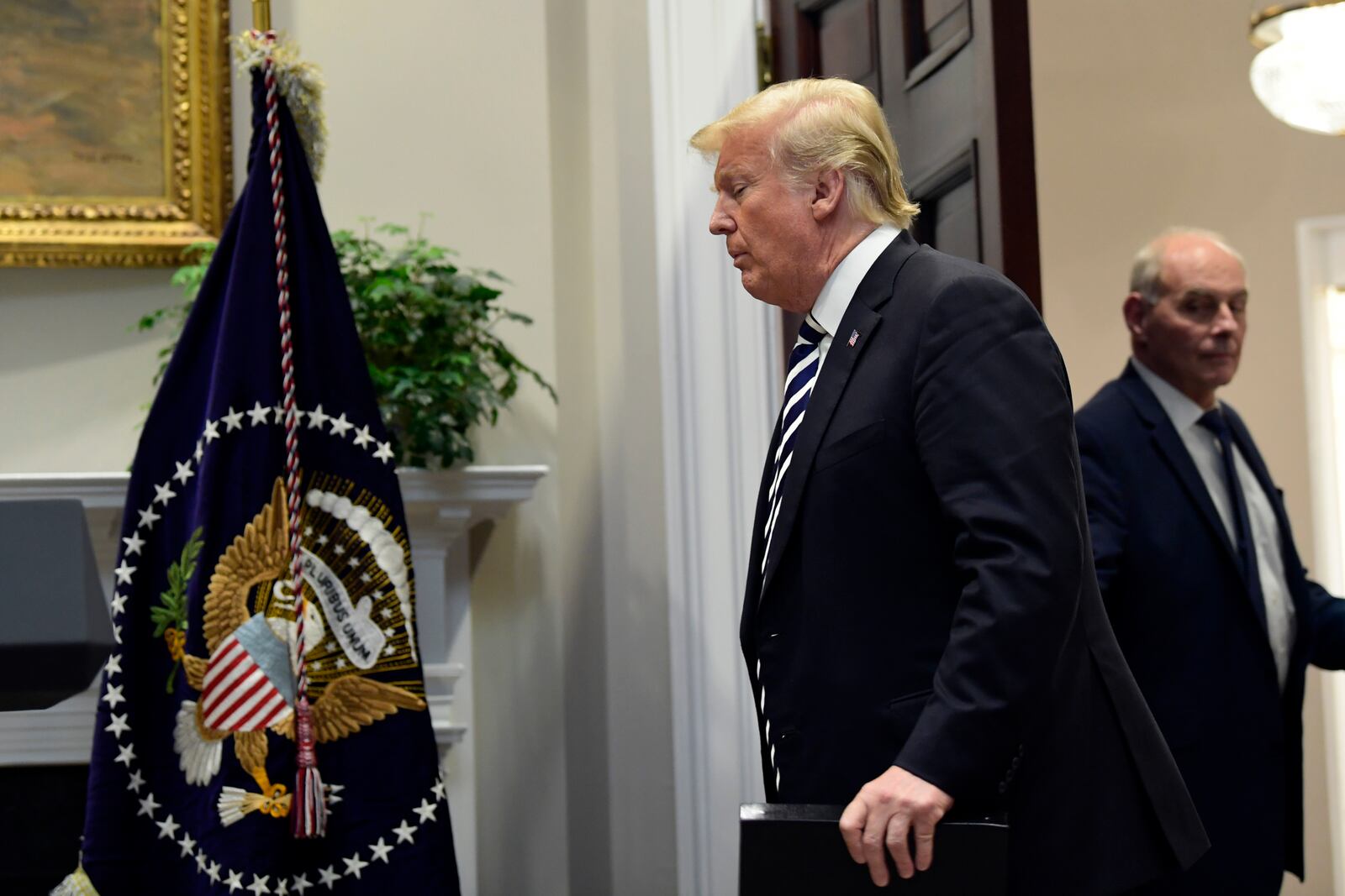 FILE - President Donald Trump walks in to the Roosevelt Room of the White House in Washington, Nov. 1, 2018. Chief of Staff John Kelly is at right. (AP Photo/Susan Walsh, File)