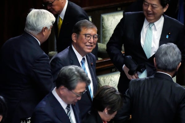 Japanese Prime Minister Shigeru Ishiba, center, reacts as he was elected for a new prime minister at a special parliamentary session of the lower house Monday, Nov. 11, 2024, in Tokyo. (AP Photo/Eugene Hoshiko)