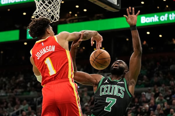 Atlanta Hawks' Jalen Johnson (1) blocks a shot by Boston Celtics' Jaylen Brown (7) during the first half of an NBA basketball game, Saturday, Jan. 18, 2025, in Boston. (AP Photo/Robert F. Bukaty)