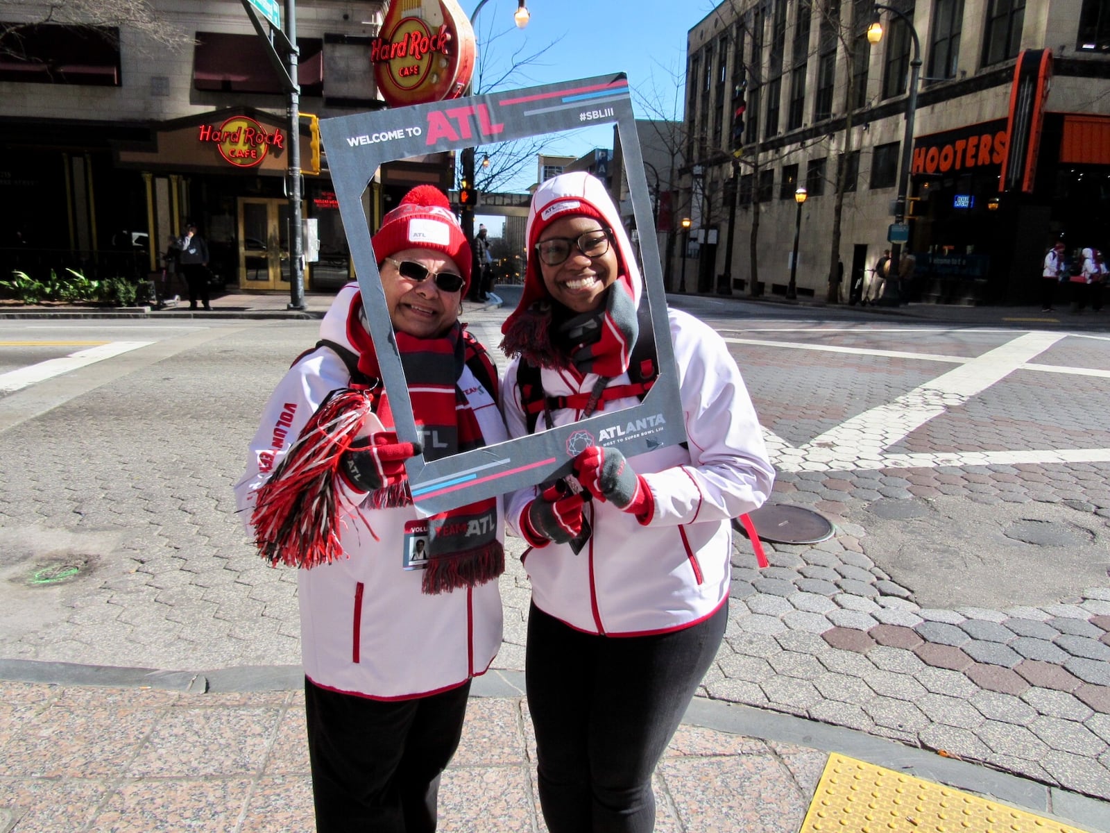 Volunteers Lillian Gouchenouer (left) and Kasey Dean make sure visitors to Atlanta for the Super Bowl feel welcome.(Photo: Jennifer Brett/jbrett@ajc.com)