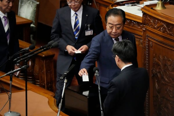 Yoshihiko Noda, leader of the Constitutional Democratic Party, votes for the new prime minister at the parliament's lower house Monday, Nov. 11, 2024, in Tokyo. (AP Photo/Eugene Hoshiko)