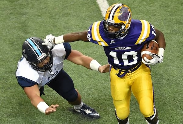 Fitzgerald's JD King carries the ball in last year's AA title game. The No. 2 Purple Hurricane will play top-ranked Benedictine on Saturday, 1 p.m. at the Georgia Dome to decide this year's AA title. (Brant Sanderlin for the AJC)