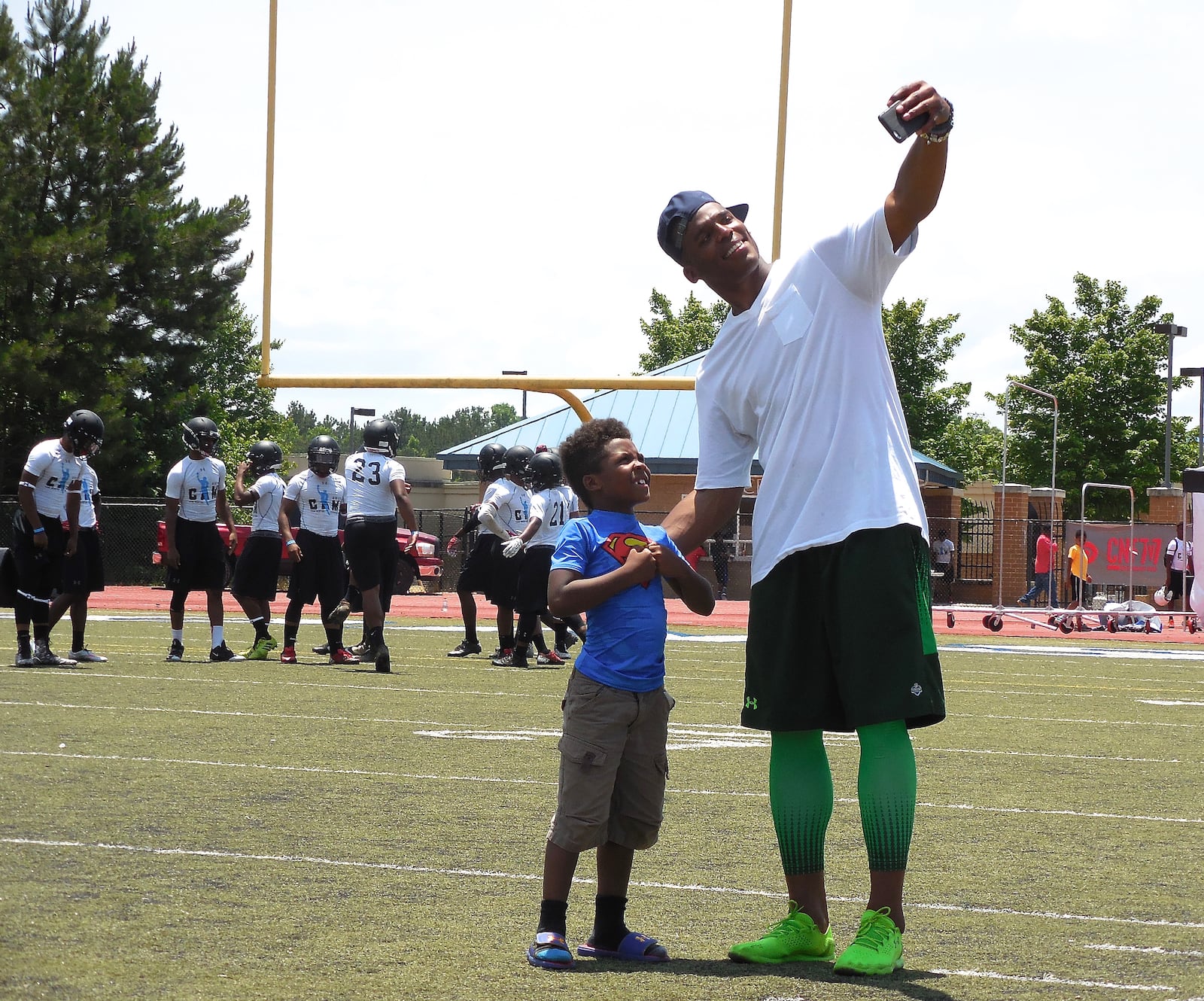 Carolina Panthers QB and Westlake High School alum Cam Newton poses for a selfie with a young superhero! Photo: Jennifer Brett