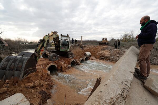 Workers repair a bridge over the Assi river in Qusair, Syria, Thursday, Nov. 28, 2024, damaged in an Israeli airstrike earlier in the month. (AP Photo/Omar Sanadiki)