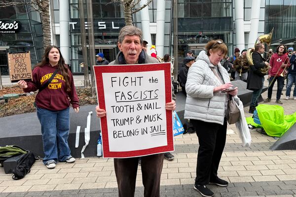 Protesters rally outside of a Tesla store in Boston, Saturday, March 1, 2025, against the company's CEO, Elon Musk, who is leading an effort to cut government jobs on behalf of President Donald Trump. (AP Photo/Rodrique Ngowi)