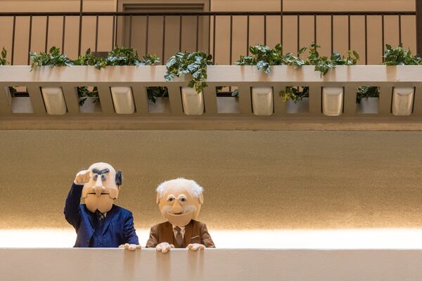 People dressed as muppets Statler and Waldorf watch over the crowd during Dragon Con in downtown Atlanta on Friday, August 30, 2024. (Arvin Temkar / AJC)