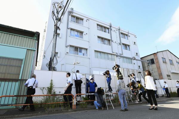 Members of Public Security Intelligence Agency leave the building housing Aum’s main successor, Aleph, after inspection in Tokyo, on July 26, 2018. (Kyodo News via AP)