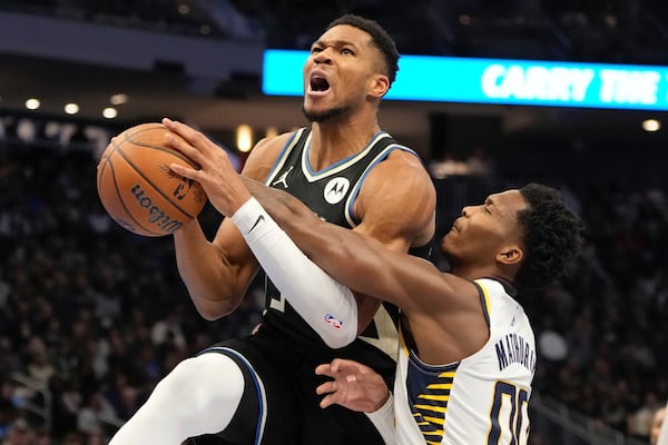 Milwaukee Bucks' Giannis Antetokounmpo is fouled by Indiana Pacers' Bennedict Mathurin during the first half of an Emirates NBA cup tournament basketball game Friday, Nov. 22, 2024, in Milwaukee. (AP Photo/Morry Gash)