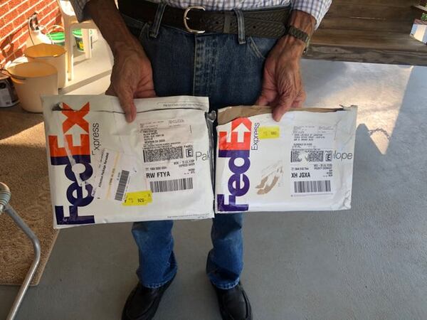 This is a picture of the 93-year-old man receiving the FedEx package that contained his $14,000.