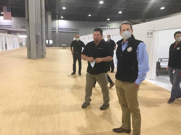 Gov. Brian Kemp tours a newly built surge hospital within the Georgia World Congress Center.