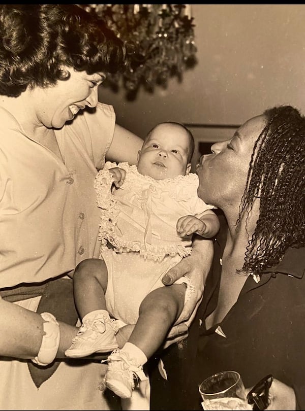 Valerie Jackson (left), widow of former Atlanta Mayor Maynard Jackson, holds her daughter Valerie Amanda next to Robert Flack (far right). Handout.