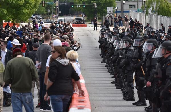 Barricades and fencing are in place around a city park in Newnan as police prepared for Saturday's rally by a neo-Nazi group on Saturday, April 21, 2018. The neo-Nazis expected a turnout of 50 to 100, but only a couple dozen showed up. They were well outnumbered by counterprotesters and law enforcement officers. (HYOSUB SHIN / AJC)