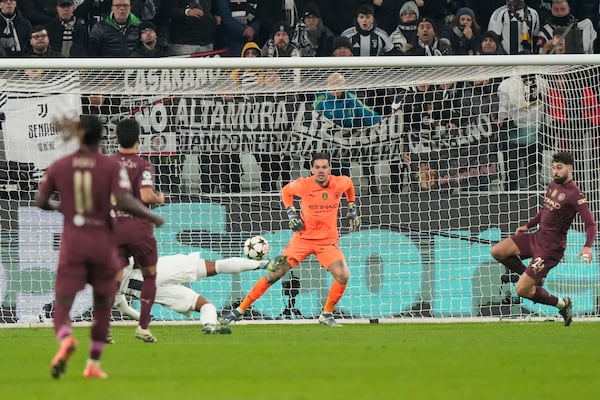 Juventus' Weston McKennie, bottom, scores his side's second goal during the Champions League, opening phase soccer match between Juventus and Manchester City at the Allianz stadium in Turin, Italy, Tuesday, Wednesday, Dec.11, 2024. (AP Photo/Luca Bruno)