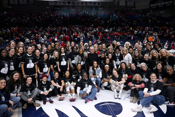 UConn head coach Geno Auriemma poses for a photograph with his players past and present and coaches as he is honored for the most wins in college basketball history, Wednesday, Nov. 20, 2024, in Storrs, Conn. (AP Photo/Jessica Hill)