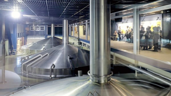 Visitors to the Kirin Brewery in Yokohama, Japan, can observe the upper portions of the huge boiling kettles in the preparation chamber. Japan News-Yomiuri photo