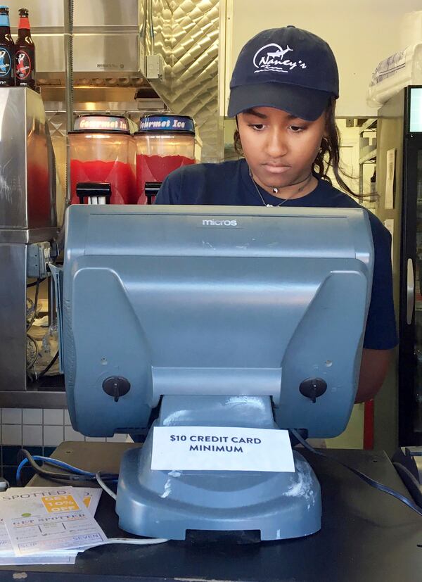 Sasha Obama, daughter of President Barack Obama, works the register at Nancy's Restaurant in Oak Bluffs, Mass., on the island of Martha's Vineyard. (Boston Herald, Christopher Evans via AP)