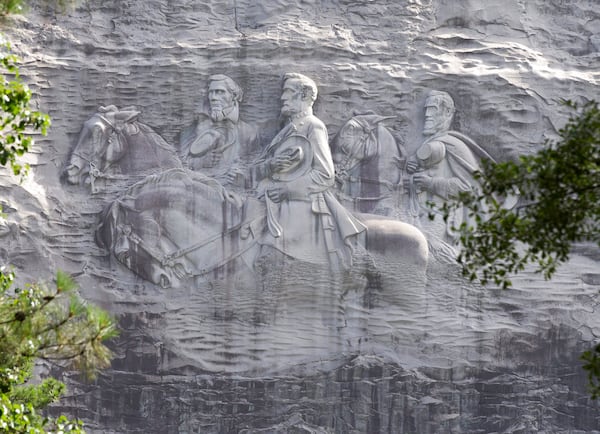 FILE - This June 23, 2015, file photo shows a carving depicting confederates Stonewall Jackson, Robert E. Lee and Jefferson Davis, in Stone Mountain, Georgia.