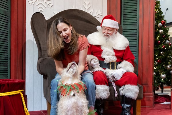 Dawn Farber and her dog Callie get ready to take pictures with Santa at Perimeter Mall in Dunwoody on Monday, November 18, 2024. (Arvin Temkar / AJC)