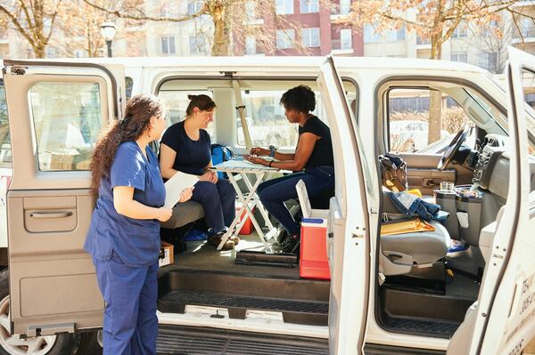 From left, Kharen Bamaca Forkel, receives training from Helen Baker and Nicholie Brown.