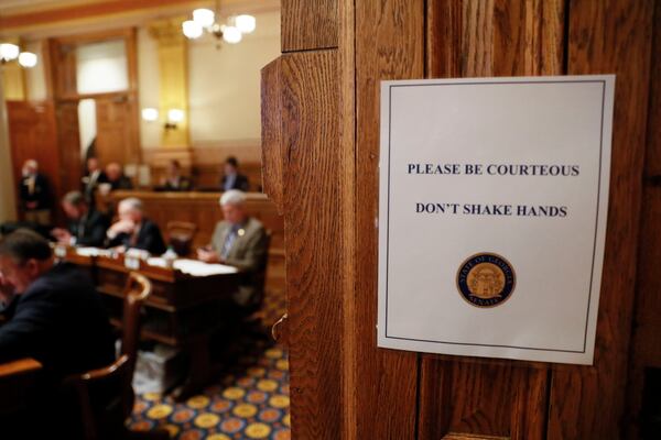 March 16, 2020 - Atlanta - Signs in the senate chamber say "Don't shake hands".  Georgia lawmakers gathered in an extraordinary special session on Monday and voted to grant Gov. Brian Kemp sweeping new powers to respond to the coronavirus pandemic. It's the first time in state history a governor has declared a public health emergency, and Kemp cast it as essential to deploy all available resources to contain a disease that's sickened dozens of Georgians and has killed one.    Bob Andres / robert.andres@ajc.com