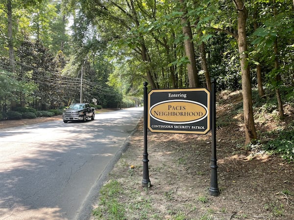 A sign greeting those entering the woodsy and high-end Paces neighborhood in west Buckhead lets drivers know they very well might be watched. Photo by Bill Torpy