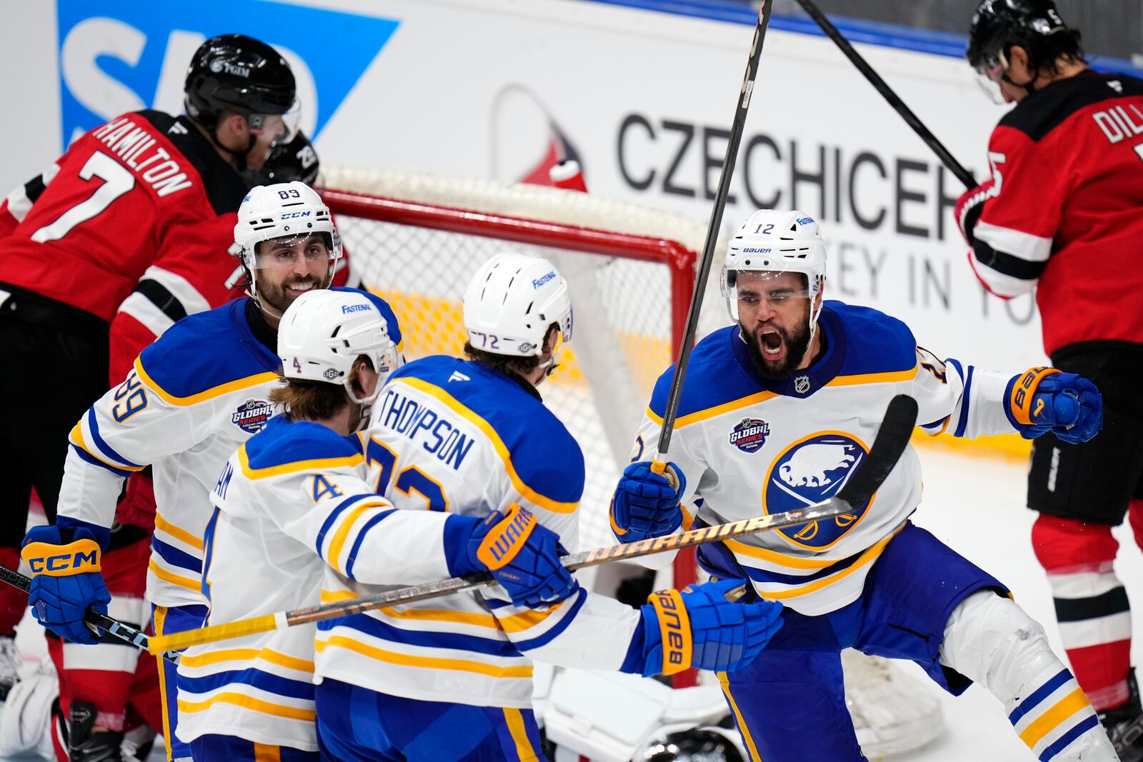 Buffalo Sabres' Tage Thompson, center, celebrates with teammates after scoring his sides first goal during the NHL hockey game between Buffalo Sabres and New Jersey Devils, in Prague, Czech Republic, Saturday, Oct. 5, 2024. (AP Photo/Petr David Josek)