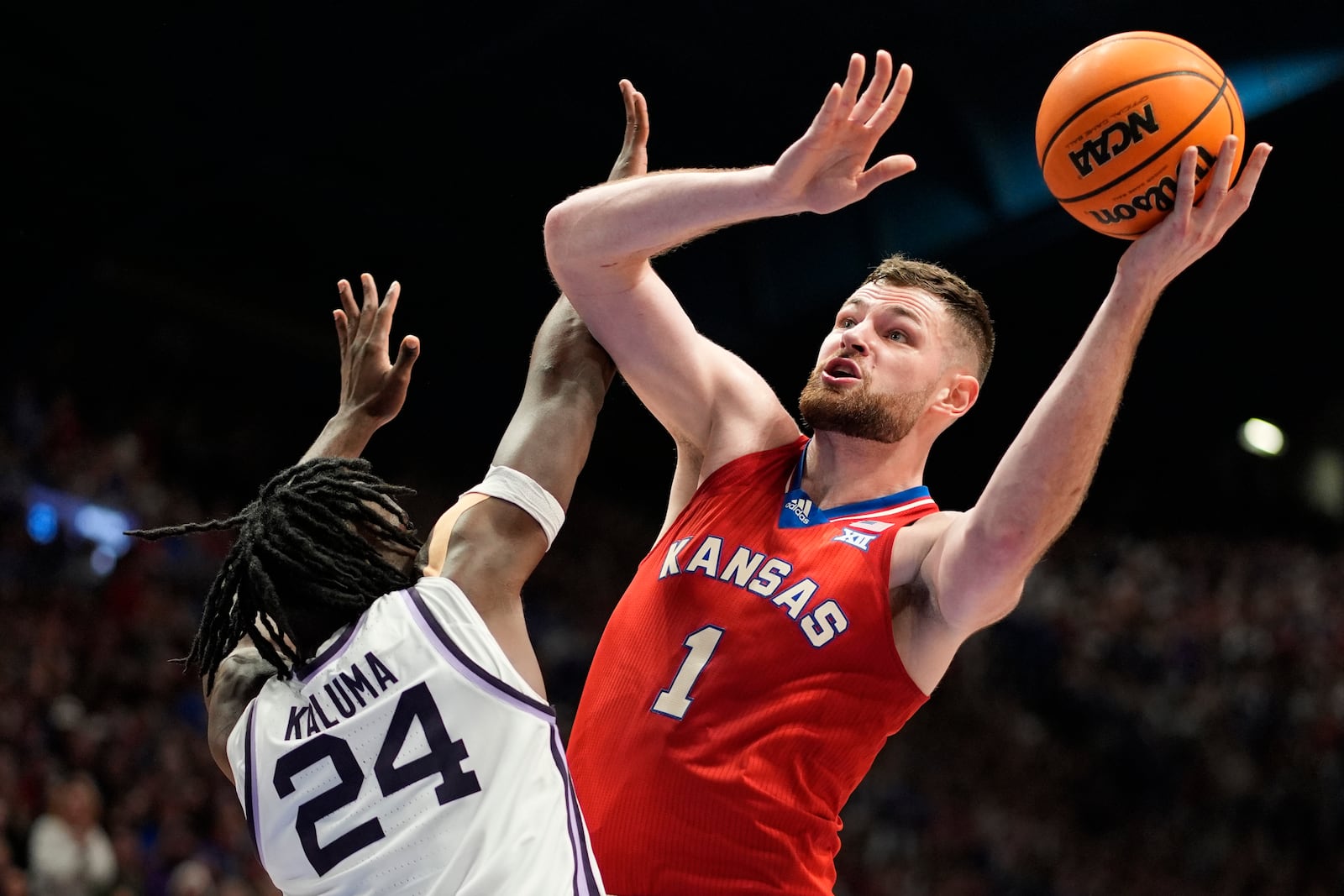 FILE - Kansas center Hunter Dickinson (1) shoots under pressure from Kansas State forward Arthur Kaluma (24) during the first half of an NCAA college basketball game Tuesday, March 5, 2024, in Lawrence, Kan. (AP Photo/Charlie Riedel, File)