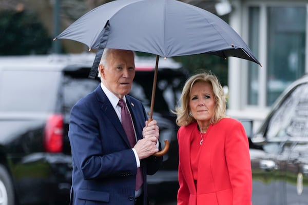 President Joe Biden and first lady Jill Biden stand ready for a group photograph with White House staff members outside the White House, Friday, Dec. 20, 2024 in Washington. (AP Photo/Ben Curtis)