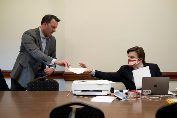 FILE - Georgia Republican Burt Jones, then a state senator and now lieutenant governor, hands in an electoral certificate claiming to be a duly chosen elector for Donald Trump on Dec. 14, 2020, at the Georgia Capitol in Atlanta. A lawsuit heard on Monday, Dec. 18, 2023, argued Jones should be disqualified from holding office in Georgia because of his actions as an elector. (AP Photo/Ben Gray, File)