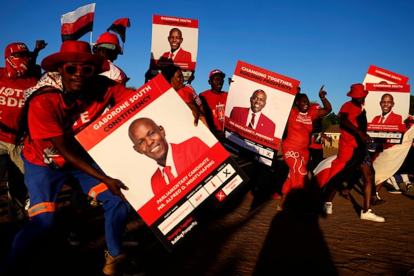 Members of the Botswana Democratic Party sing and dance as they arrive for their election rally, a day before elections in Gaborone, Botswana, Tuesday, Oct. 29, 2024. (AP Photo/Themba Hadebe)