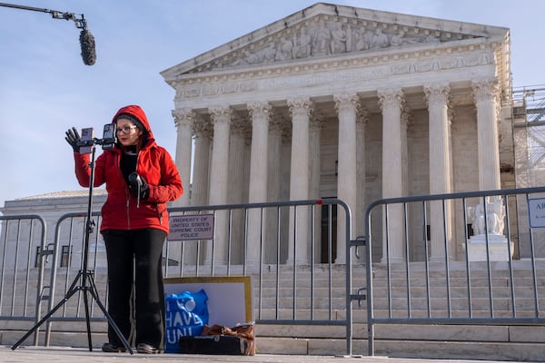 Tiffany Cianci, who says she is a "long form educational content creator," livestreams to TikTok, outside the Supreme Court, Friday, Jan. 10, 2025, in Washington. (AP Photo/Jacquelyn Martin)