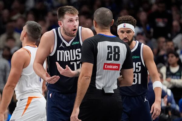 Dallas Mavericks guard Luka Doncic (77) questions a call to referee Mousa Dagher (28) as guard Klay Thompson (31) looks on during the second half of an NBA basketball game against the Phoenix Suns Friday, Nov. 8, 2024, in Dallas. (AP Photo/LM Otero)