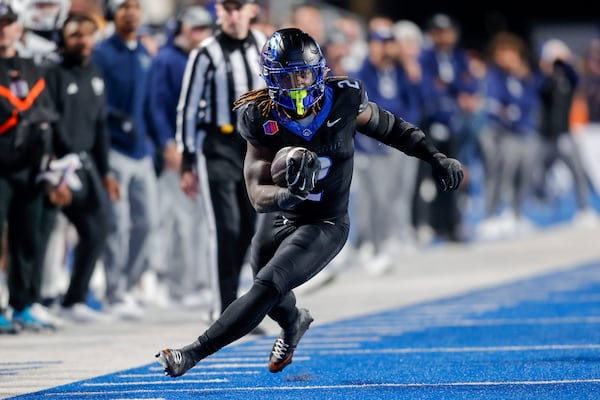 Boise State running back Ashton Jeanty (2) turns up field in front of the Nevada bench on a run in the first half of an NCAA college football game, Saturday, Nov. 9, 2024, in Boise, Idaho. (AP Photo/Steve Conner)