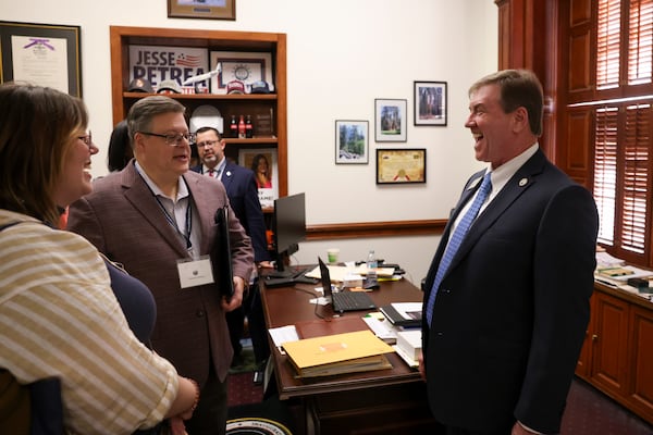 Patrick Kelsey, a member of the Georgians for the Arts (second from left), visits with state Rep. Jesse Petrea, R-Savannah, at his office at the Capitol in February. A group of arts advocates met with lawmakers to discuss art funding. (Jason Getz / AJC)