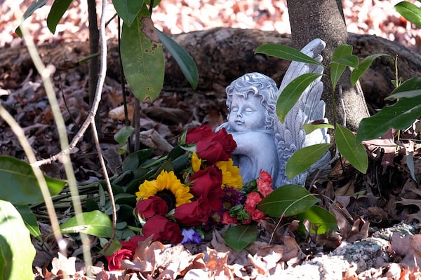 Lori Ellis and her husband, of Watkinsville, GA, placed an angel where Laken Riley was killed on the University of Georgia campus. Others placed fresh roses there on Saturday, Feb. 22, 2025, the one-year anniversary of Riley's death.  
(Nell Carroll for The Atlanta Journal-Constitution)
