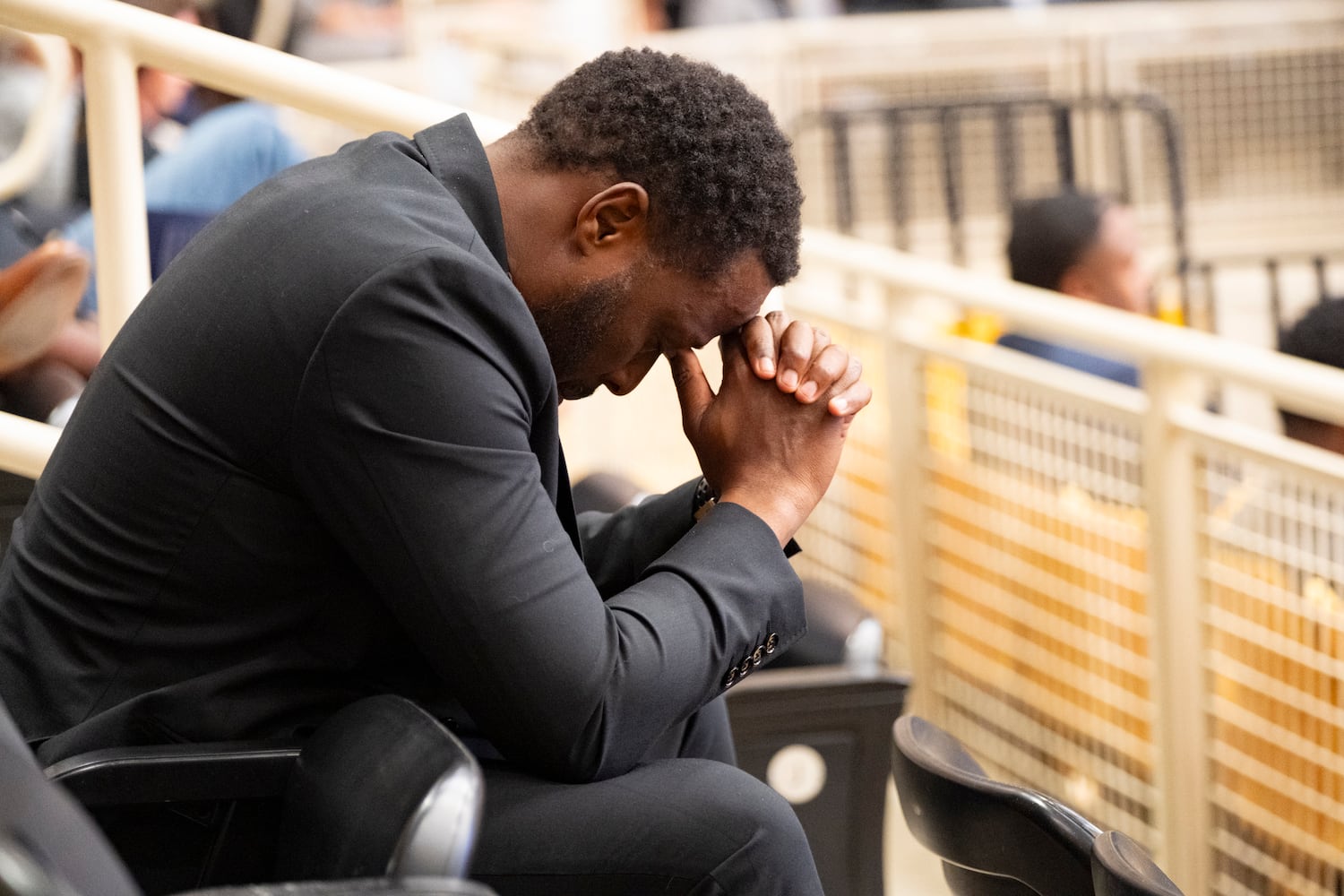 A man bows his head in prayer at the opening of a celebration of life for former Kennesaw State University basketball coach Amir Abdur-Rahim at the KSU convocation center on Sunday, Oct. 27, 2024.   Ben Gray for the Atlanta Journal-Constitution